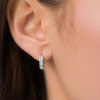 Thumbnail Image 3 of 1/10 CT. T.W. Diamond Huggie Hoop Earrings in 10K White Gold