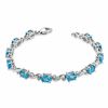 Thumbnail Image 1 of Oval Blue Topaz and Diamond Accent Bracelet in Sterling Silver - 7.25"