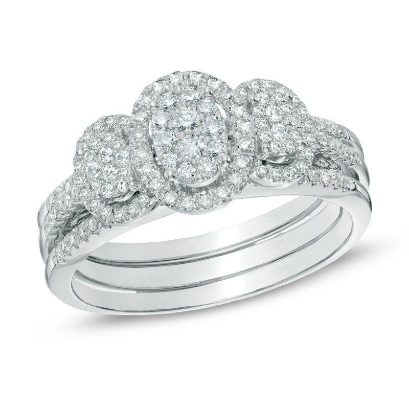 Main Image 1 of 1/2 CT. T.W. Diamond Oval Frame Three Stone Cluster Three Piece Bridal Set in 10K White Gold