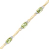 Thumbnail Image 0 of Oval Peridot and Diamond Accent Bracelet in Sterling Silver and 10K Gold Plate - 7.25"