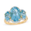 Thumbnail Image 1 of Oval Blue Topaz and 1/5 CT. T.W. Diamond Frame Three Stone Ring in 14K Gold