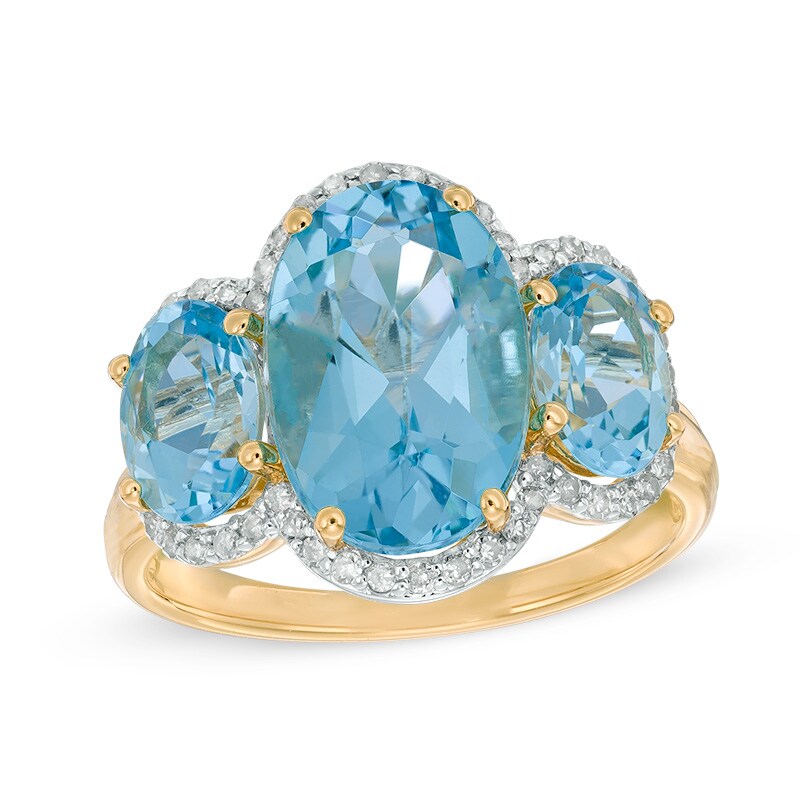 Main Image 1 of Oval Blue Topaz and 1/5 CT. T.W. Diamond Frame Three Stone Ring in 14K Gold