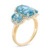 Thumbnail Image 2 of Oval Blue Topaz and 1/5 CT. T.W. Diamond Frame Three Stone Ring in 14K Gold