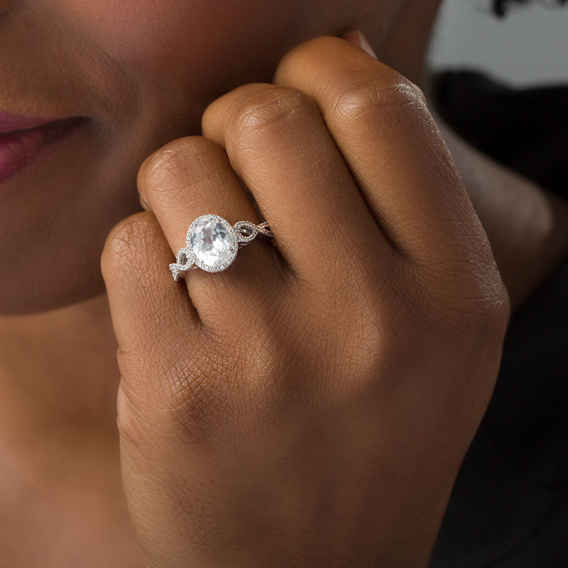 Oval Lab-Created White Sapphire and 1/6 CT. T.W. Diamond Frame Infinity Shank Engagement Ring in Sterling Silver