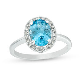 Oval Blue Topaz and 1/8 CT. T.W. Diamond Frame Engagement Ring in 14K White Gold