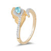 Thumbnail Image 1 of Enchanted Disney Jasmine Pear-Shaped Blue Topaz and 1/6 CT. T.W. Diamond Peacock Feather Bypass Wrap Ring in 10K Gold