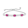 Thumbnail Image 1 of Oval Lab-Created Ruby and White Sapphire Frame Three Stone Bolo Bracelet in Sterling Silver - 9.5"