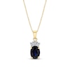 Thumbnail Image 0 of Oval Blue Sapphire and 1/15 CT. T.W. Baguette Diamond Crown Drop Pendant in 14K Gold