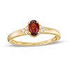 Thumbnail Image 1 of Oval Garnet and 1/20 CT. T.W. Diamond Tri-Sides Ring in 10K Gold - Size 7