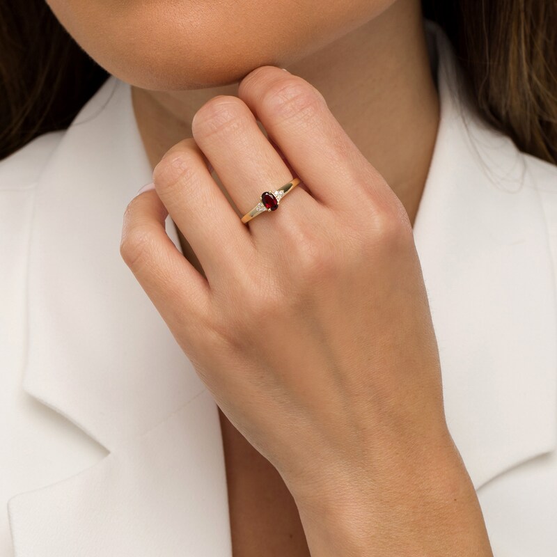 Main Image 2 of Oval Garnet and 1/20 CT. T.W. Diamond Tri-Sides Ring in 10K Gold - Size 7