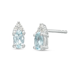 Oval Aquamarine and 1/20 CT. T.W. Diamond Stud Earrings in 10K White Gold