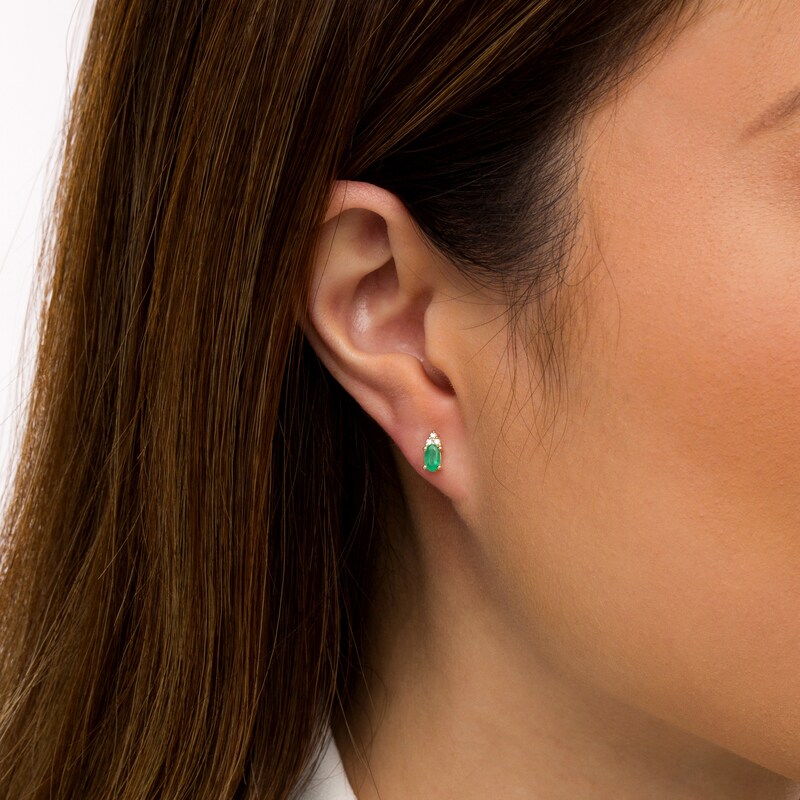 Main Image 2 of Oval Emerald and 1/20 CT. T.W. Diamond Stud Earrings in 10K Gold