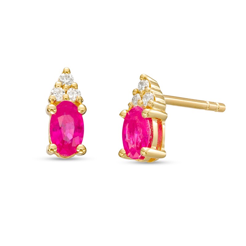 Main Image 1 of Oval Ruby and 1/20 CT. T.W. Diamond Stud Earrings in 10K Gold