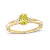Thumbnail Image 0 of Oval Peridot and 1/20 CT. T.W. Diamond Tri-Sides Ring in 10K Gold - Size 7