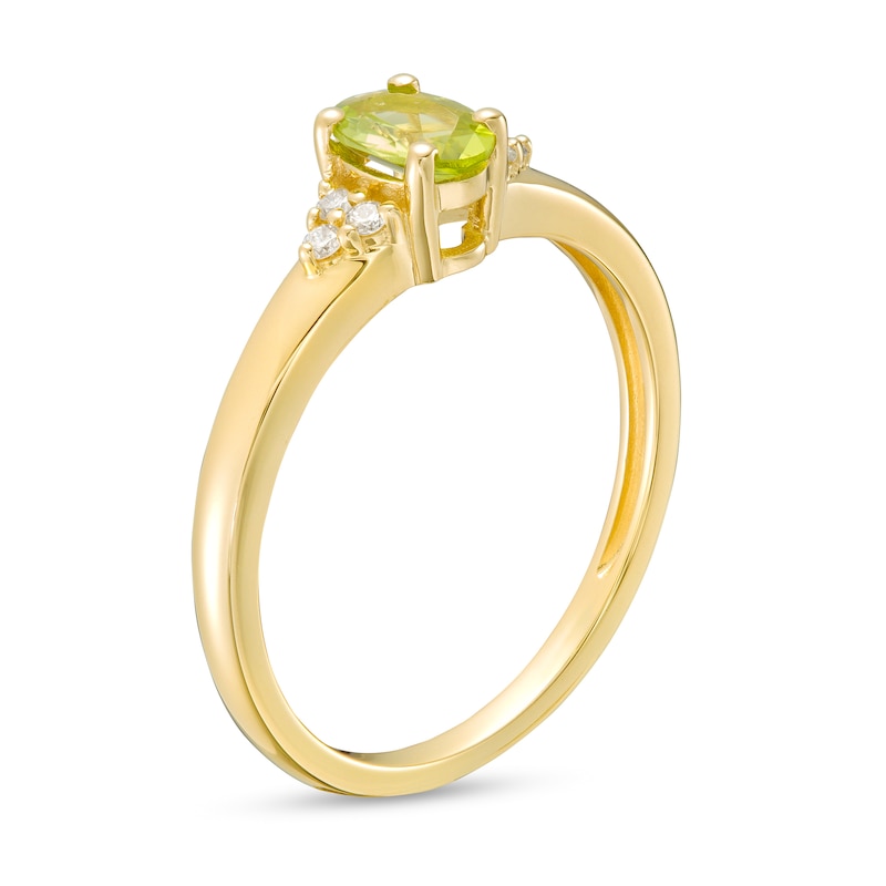 Oval Peridot and 1/20 CT. T.W. Diamond Tri-Sides Ring in 10K Gold - Size 7
