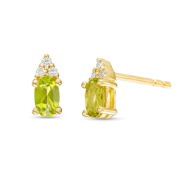 Oval Peridot and 1/20 CT. T.W. Diamond Stud Earrings in 10K Gold