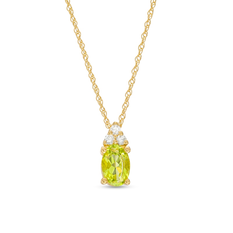 Oval Peridot and 1/20 Diamond CT. T.W. Diamond Pendant in 10K Gold