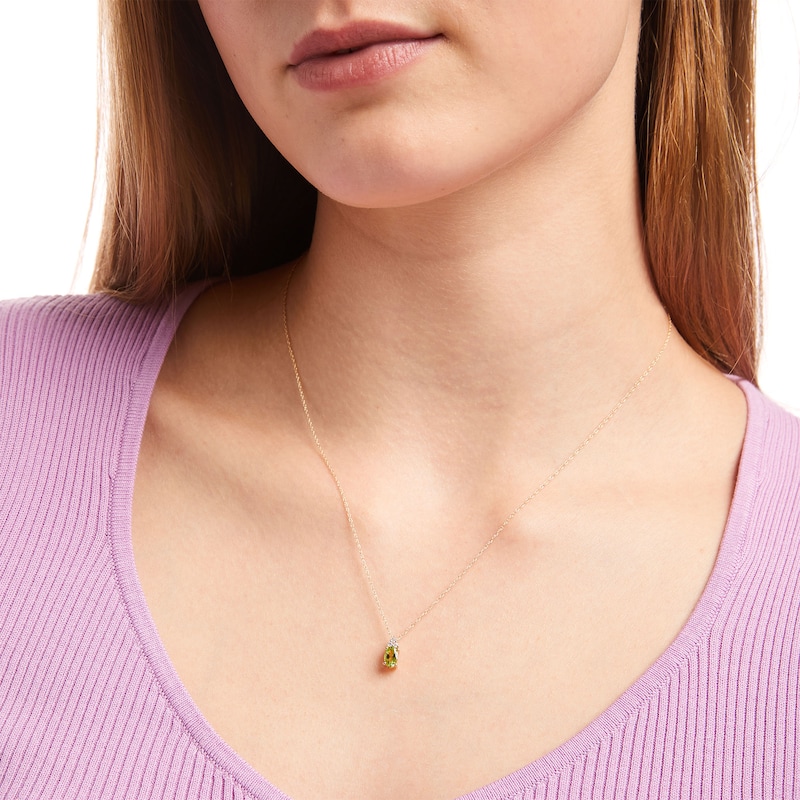 Main Image 2 of Oval Peridot and 1/20 Diamond CT. T.W. Diamond Pendant in 10K Gold