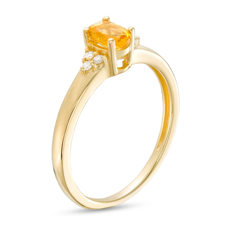 Oval Citrine and 1/20 CT. T.W. Diamond Tri-Sides Ring in 10K Gold - Size 7