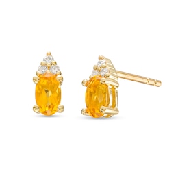 Oval Citrine and 1/20 CT. T.W. Diamond Stud Earrings in 10K Gold