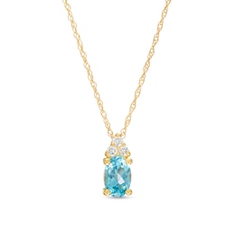 Oval Swiss Blue Topaz and 1/20 CT. T.W. Diamond Pendant in 10K Gold
