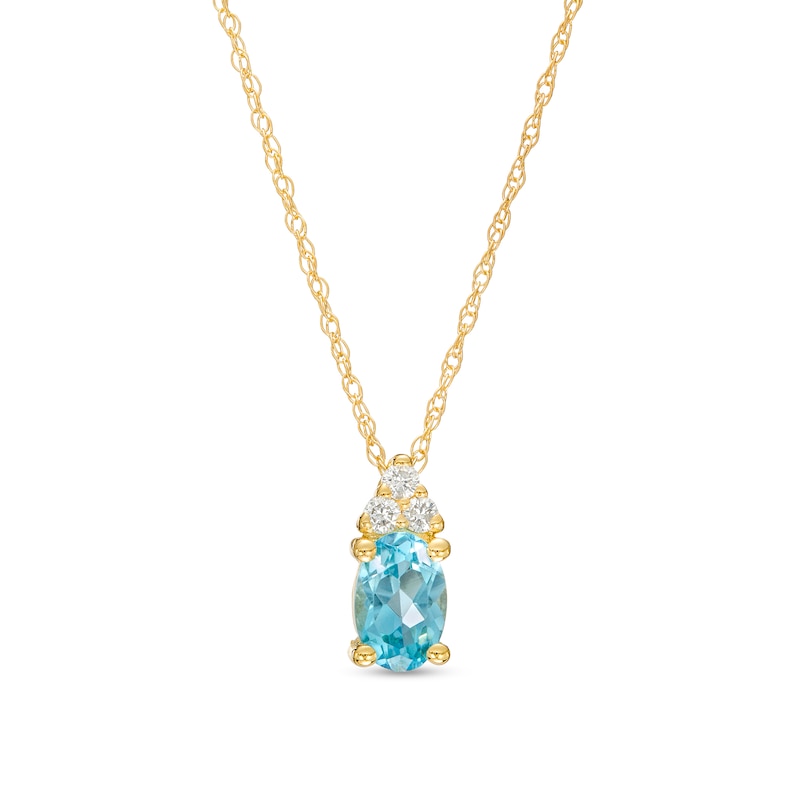 Oval Swiss Blue Topaz and 1/20 CT. T.W. Diamond Pendant in 10K Gold ...