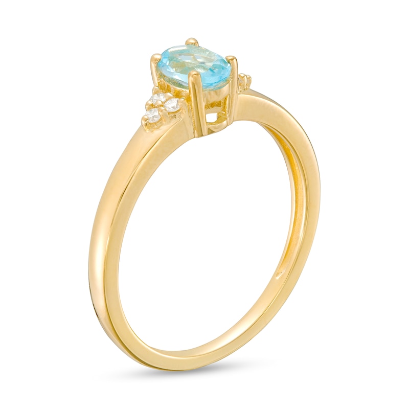 Main Image 3 of Oval Swiss Blue Topaz and 1/20 CT. T.W. Diamond Tri-Sides Ring in 10K Gold - Size 7