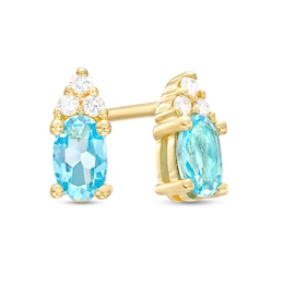 Oval Swiss Blue Topaz and 1/20 CT. T.W. Diamond Stud Earrings in 10K Gold