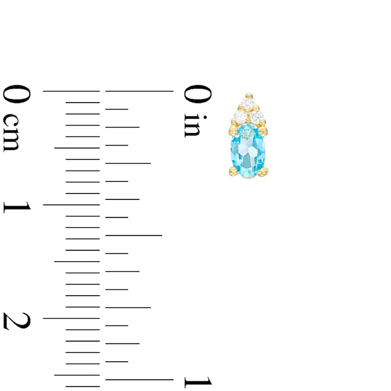 Main Image 3 of Oval Swiss Blue Topaz and 1/20 CT. T.W. Diamond Stud Earrings in 10K Gold