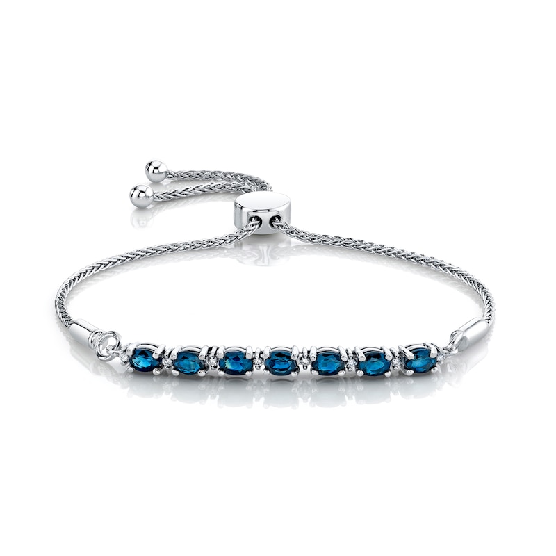 Main Image 1 of Oval Blue Sapphire and 1/15 CT. T.W. Diamond Alternating Bolo Bracelet in Sterling Silver – 12"