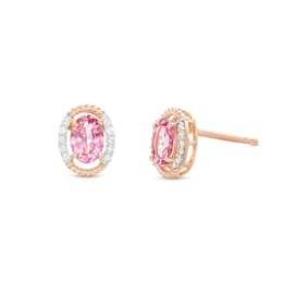 Oval Pink Garnet and 1/15 CT. T.W. Diamond Open Rope-Textured Frame Stud Earrings in 10K Rose Gold