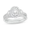 Thumbnail Image 1 of 5/8 CT. T.W. Oval Multi-Diamond Frame Three Stone Double Row Split Shank Bridal Set in 10K White Gold