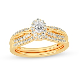 1/2 CT. T.W. Oval Diamond Frame Overlay Bridal Set in 14K Gold