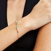 Thumbnail Image 1 of Pear-Shaped Emerald and White Topaz Open Bangle in 10K Gold - 7.25"
