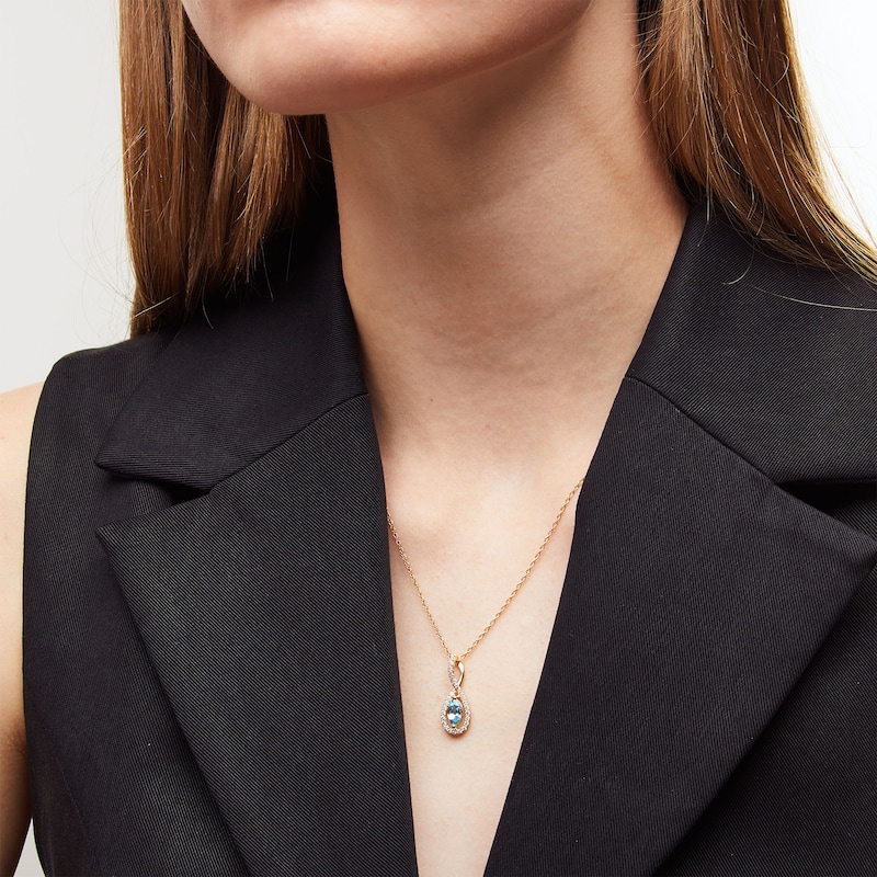 Main Image 2 of Marquise Swiss Blue Topaz and 1/5 CT. T.W. Diamond Infinity Twist Pendant in 10K Gold