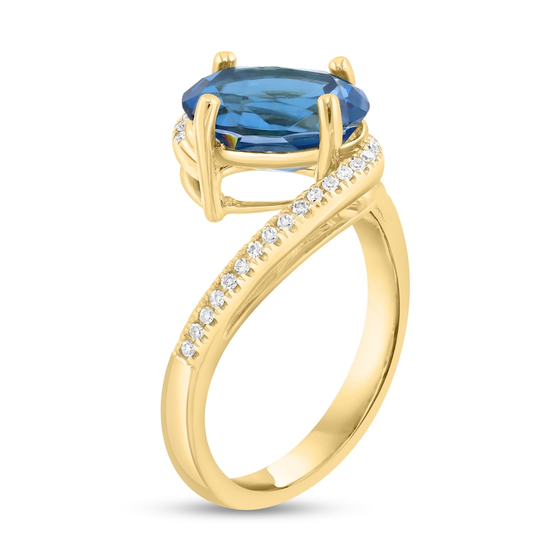 Main Image 2 of EFFY™ Oval London Blue Topaz and 1/8 CT. T.W. Diamond Bypass Ring in 14K Gold