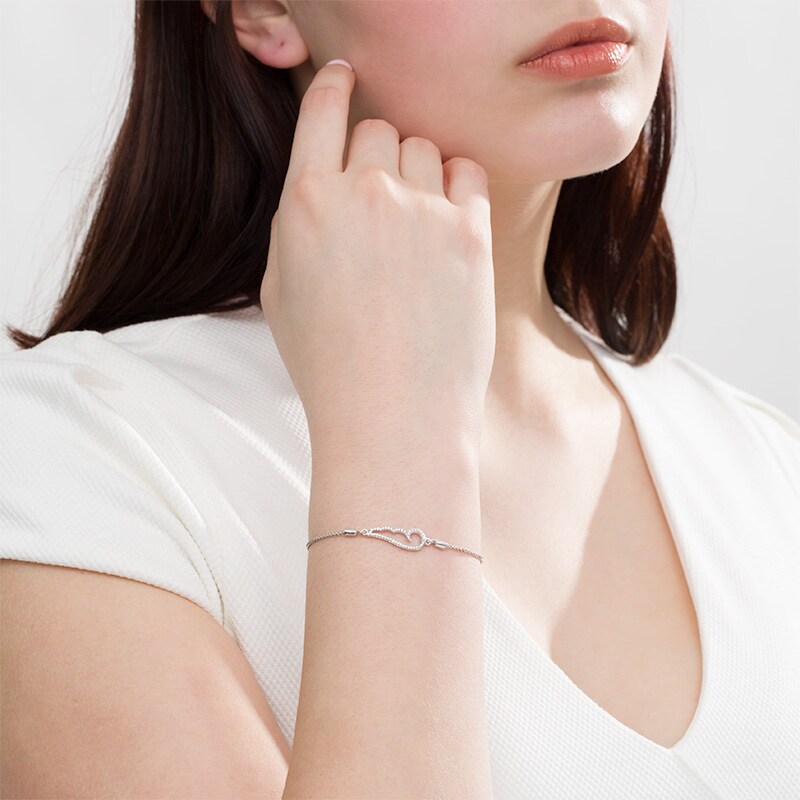 Main Image 2 of Previously Owned - 1/20 CT. T.W. Diamond Sideways Angel Wing Bolo Bracelet in Sterling Silver - 9.5"