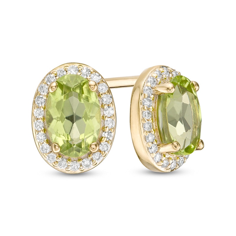 Previously Owned - Oval Peridot and 1/10 CT. T.W. Diamond Frame Stud Earrings in 10K Gold