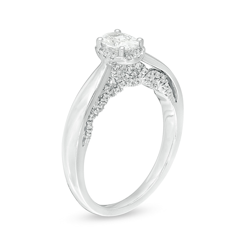 Previously Owned - Celebration Ideal 3/4 CT. T.W. Oval Diamond Frame Engagement Ring in 14K White Gold (I/I1)