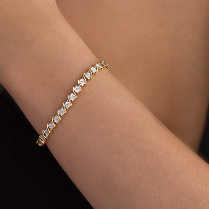 Previously Owned - 1/4 CT. T.W. Diamond "S" Tennis Bracelet in Sterling Silver with 14K Gold Plate - 7.25"